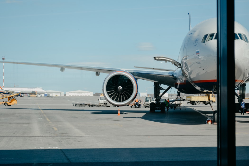 Commercial aircraft on an airport tarmac undergoing ground compliance and maintenance checks