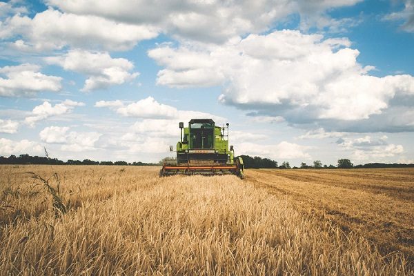 Combine harvester working a field, representing modern agriculture inspection requirements
