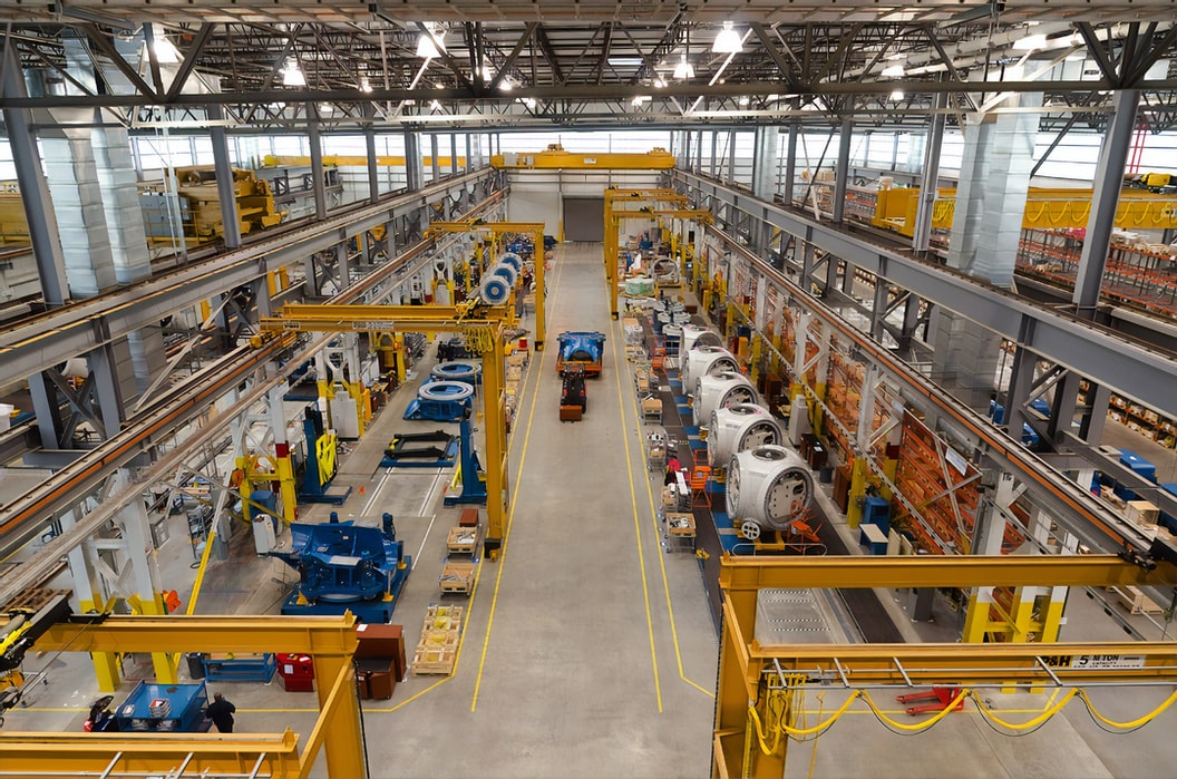 Manufacturing floor worker using digital tablet for Good Manufacturing Practice inspection
