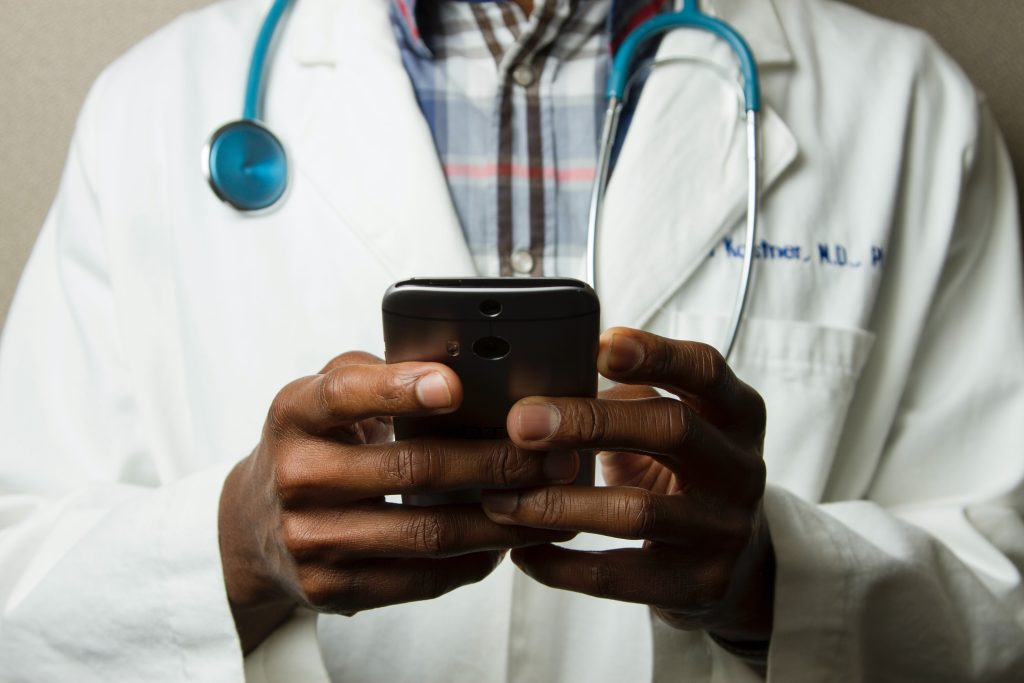 Healthcare worker conducting a digital inspection of medical equipment in a hospital setting