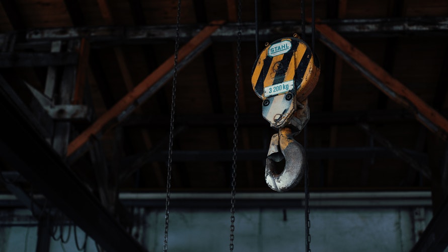 Rental hoist equipment undergoing pre-delivery inspection with digital documentation
