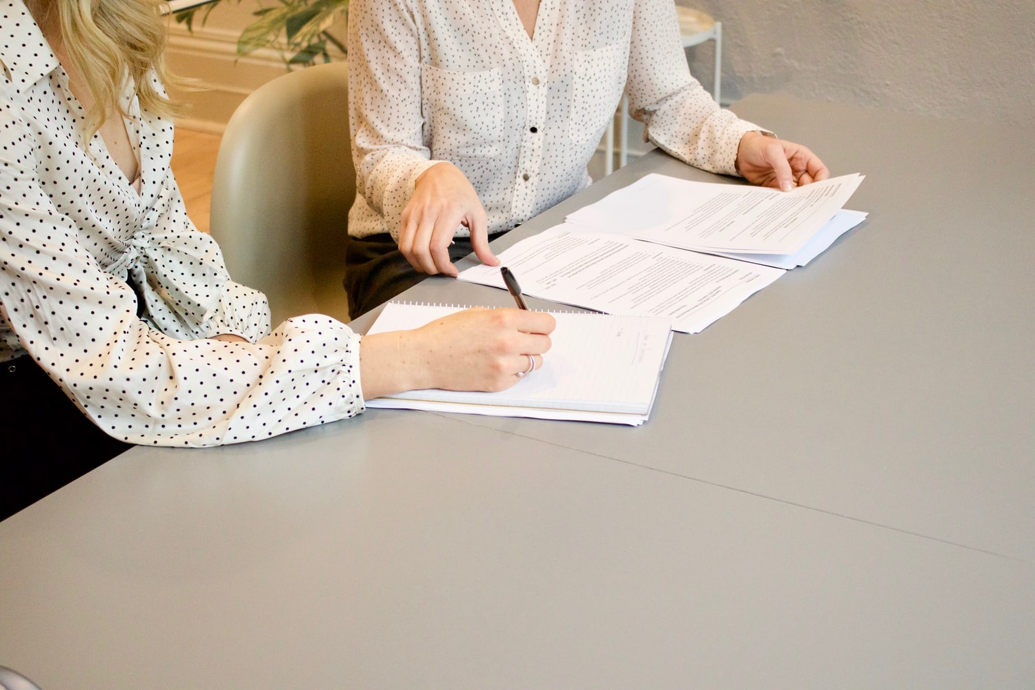 Business professional reviewing compliance documentation in an office setting, representing ISO 37301 compliance management systems