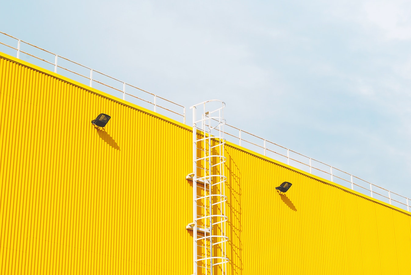 Worker using a smartphone ladder inspection application to check a portable ladder on a construction site