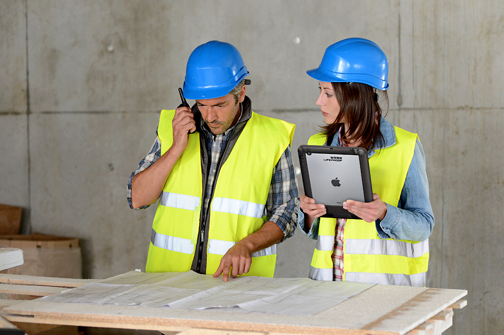 Worker inspecting specialty safety equipment on a construction site using a digital checklist