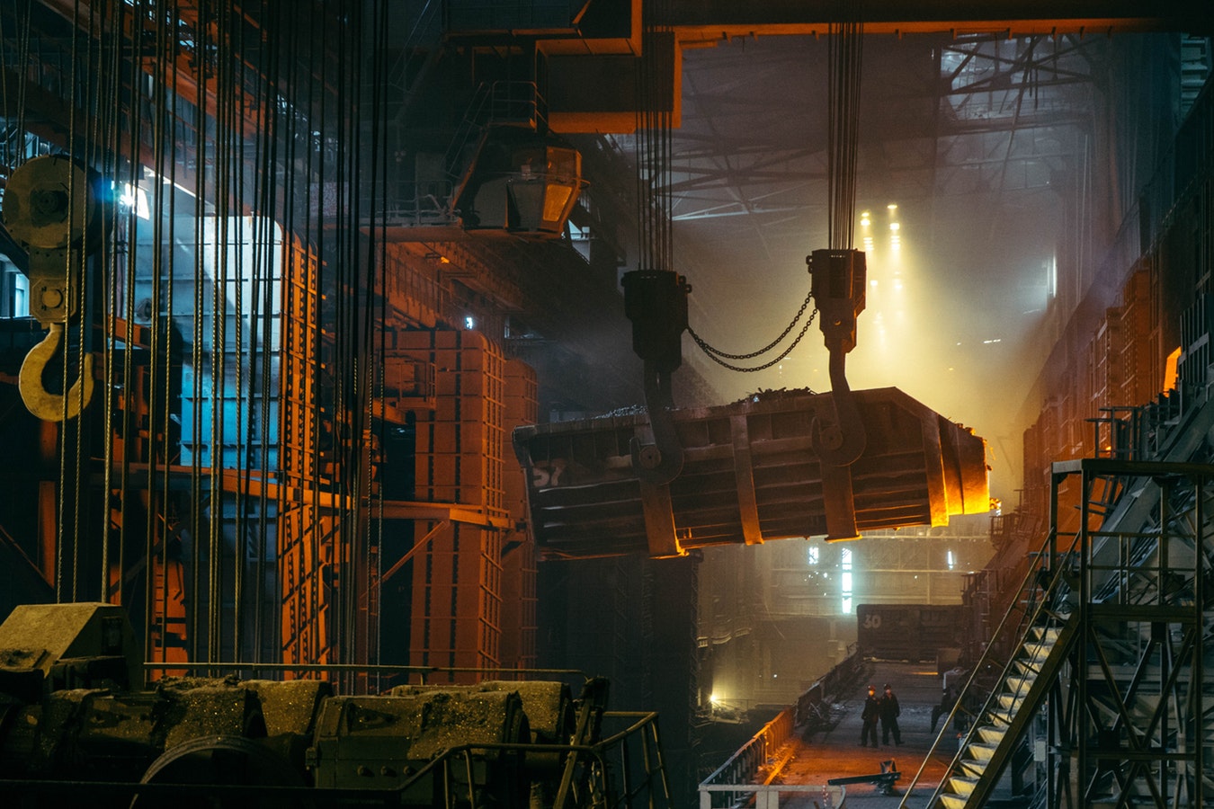 Manufacturing facility with workers using paperless digital checklists on tablets to inspect production processes