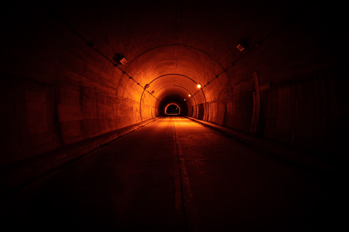Road tunnel interior showing lighting and safety systems representing tunnel safety inspection