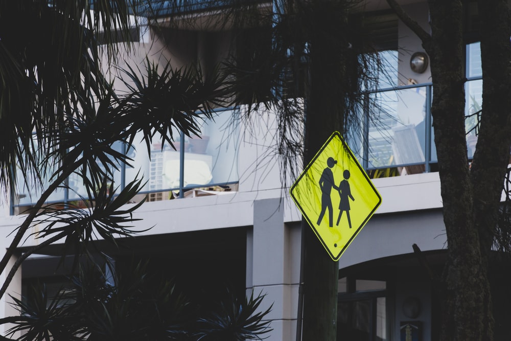 Inspector checking workplace safety signage compliance using a digital mobile inspection tool