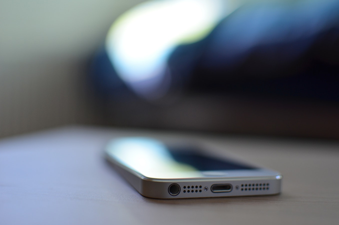 Technician using a smartphone to access CMMS asset maintenance records in the field