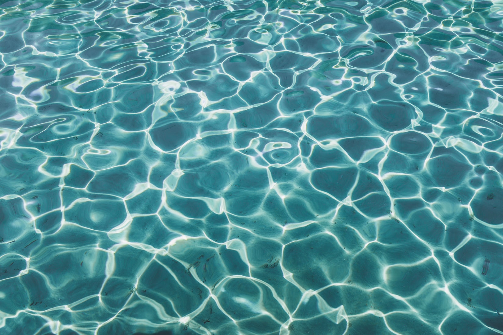 Inspector checking a swimming pool facility with a digital checklist on a tablet device