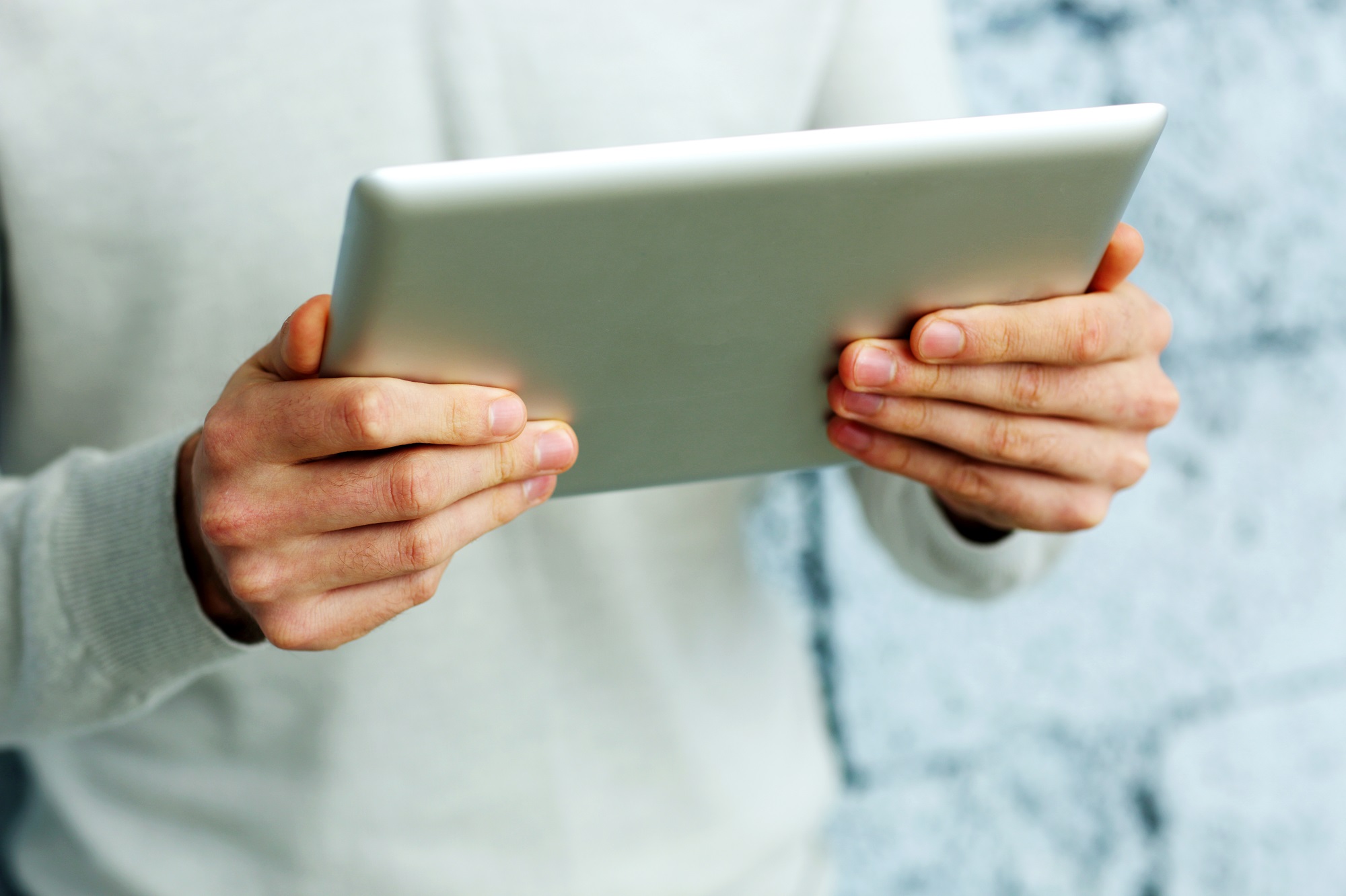 Inspector holding a tablet running a purpose-built field inspection app