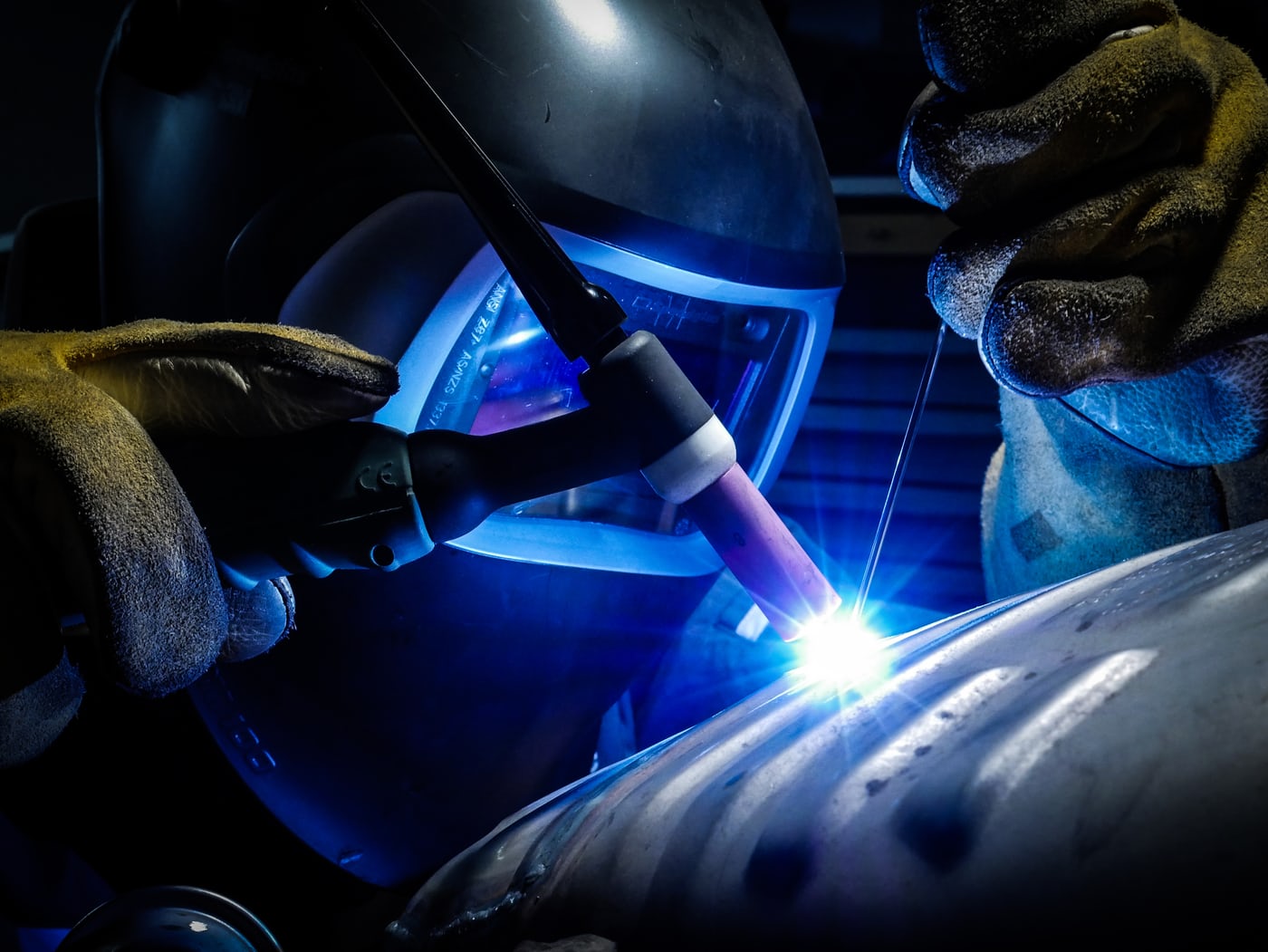 Industrial welding operation in a manufacturing environment subject to ISO 2553 welding symbol standards and inspection requirements