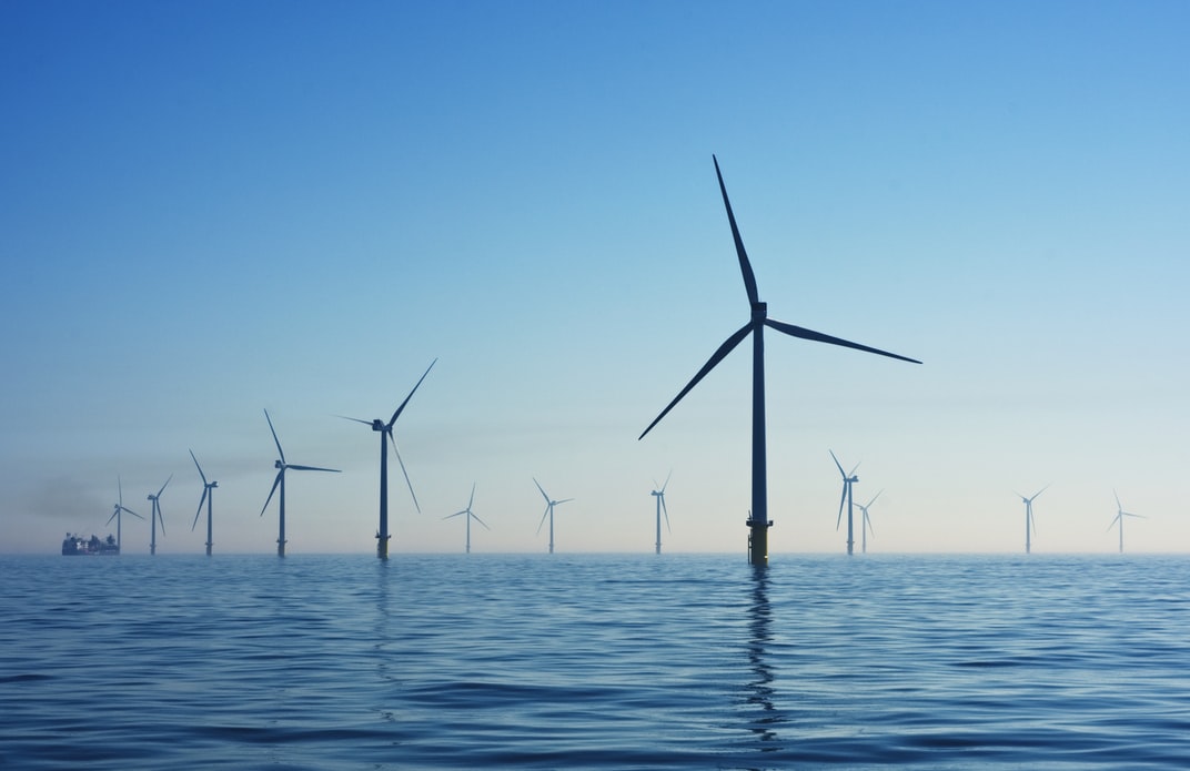 Wind turbines at an onshore wind farm installation requiring regular safety and performance inspection