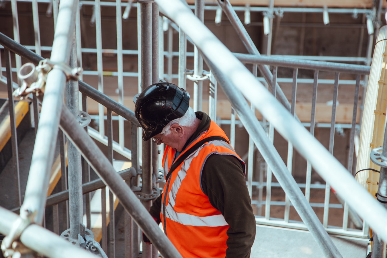 Inspector using a mobile device to complete a digital safety inspection on site